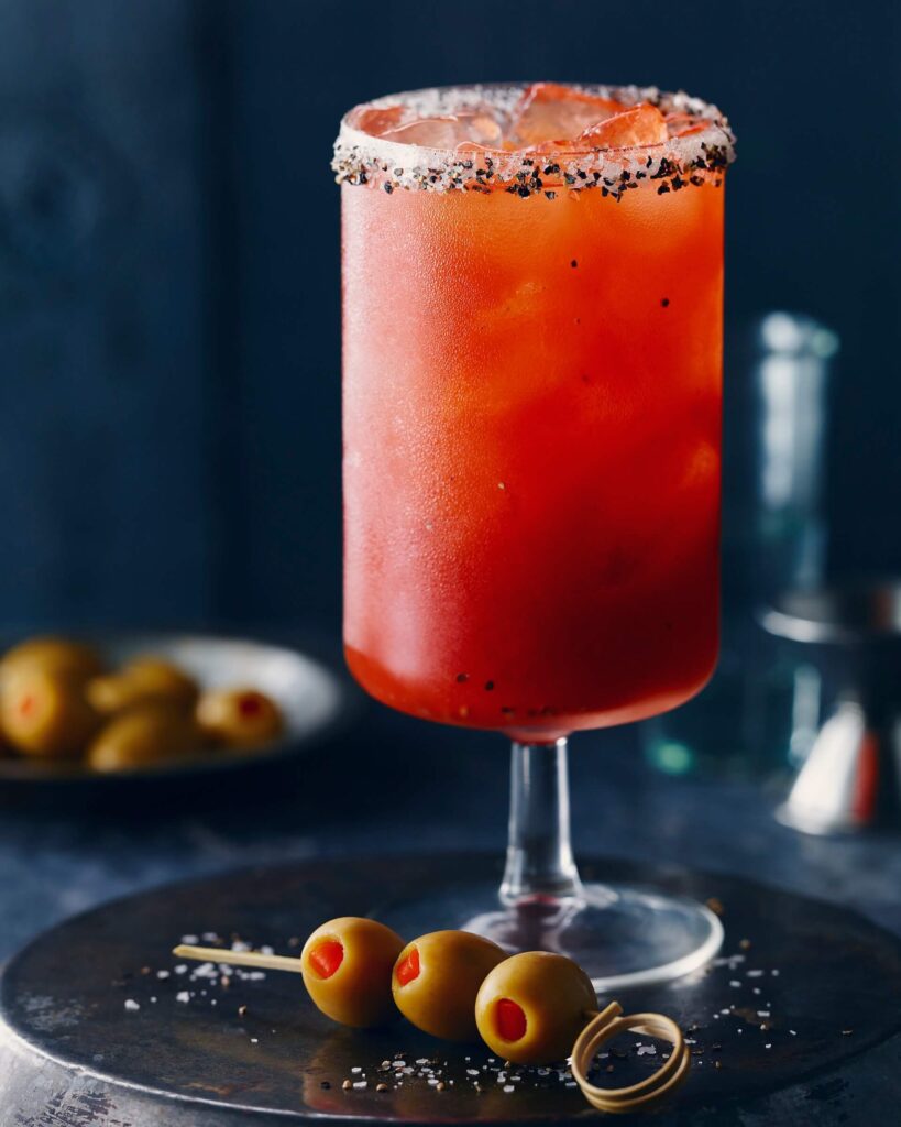 Caesar in tall glass with pimento olives